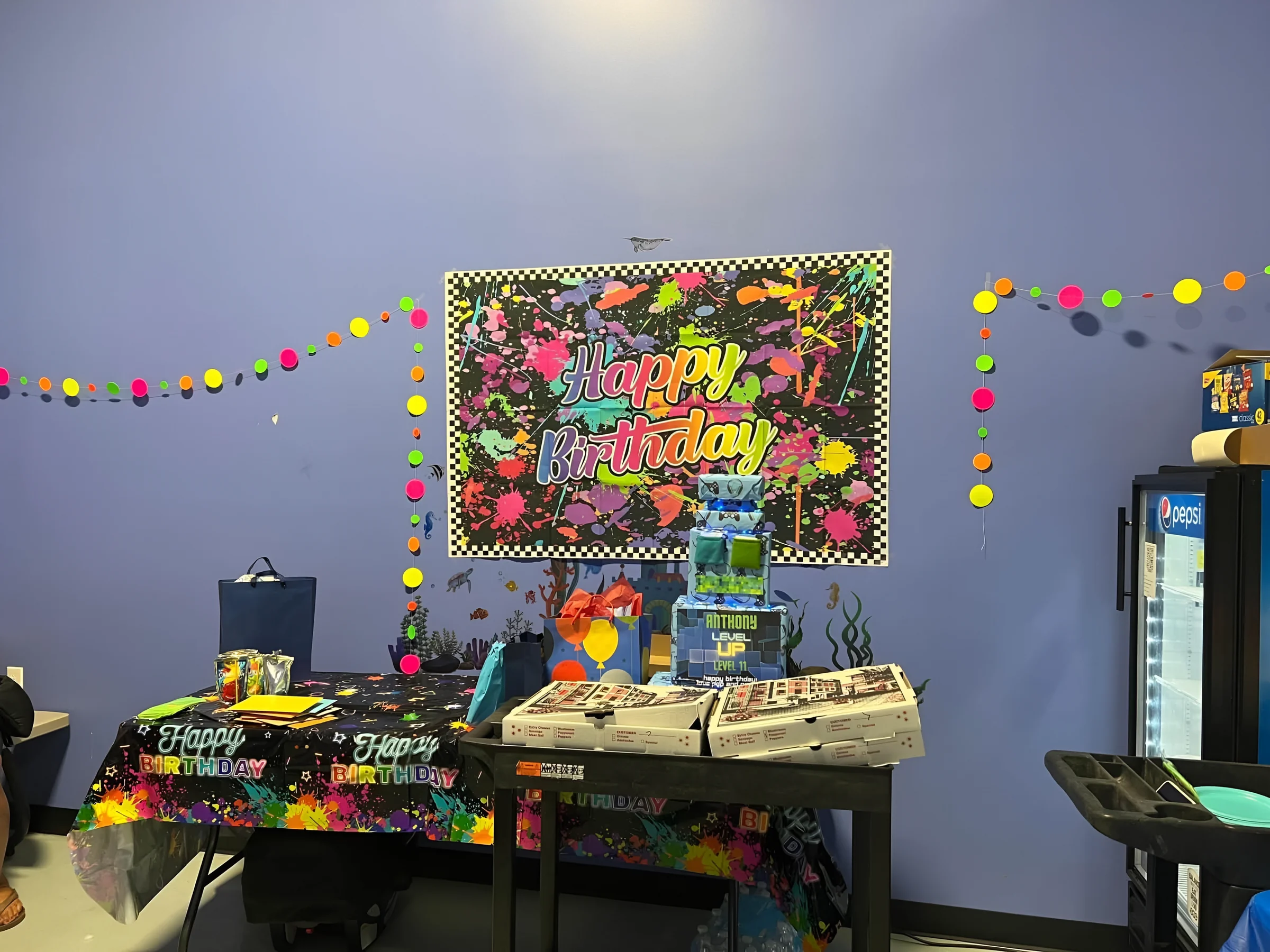 Party room with neon birthday backdrop and party table at Nova Adventure Park Cincinnati